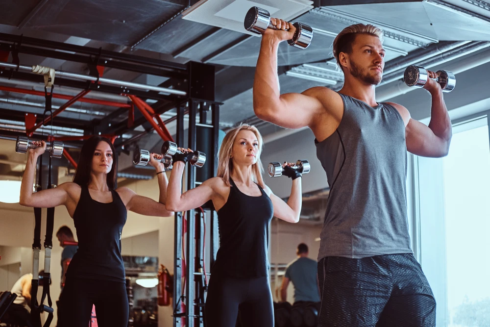 group people exercising with dumbbells fitness club gym 1